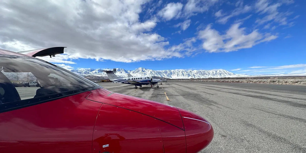 A red plane is parked on the tarmac